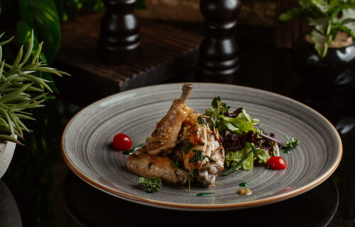 Emmer & Rye's Fresh Daily Menu - sauteed chicken pieces in blue ceramic plate with salad